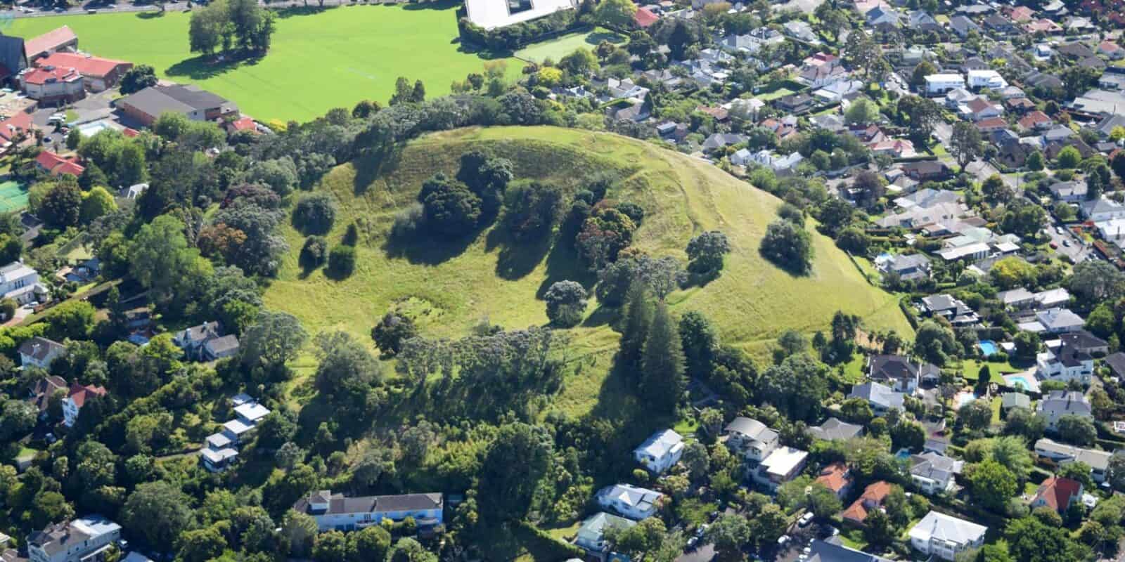 Aerial view of the tree-covered cone of Te Kōpuke / Mt St John